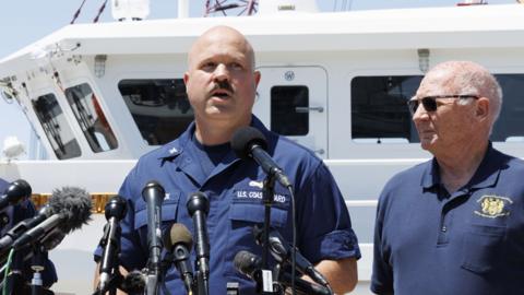 Captain Jamie Frederick briefs the news media