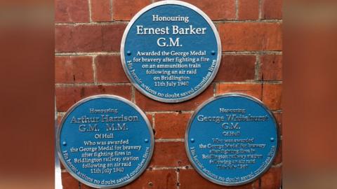 Three blue plaques