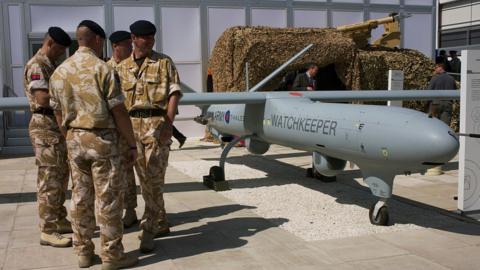 Soldiers stood by a Watchkeeper drone