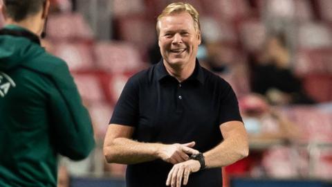 Ronald Koeman points to his watch