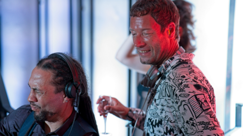 Two men standing in a DJ booth