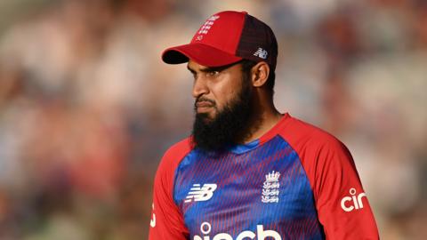 Adil Rashid watches on while playing for England