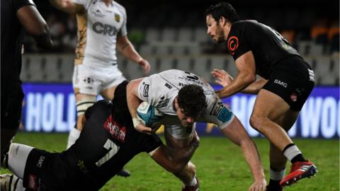 Dragons' Will Rowlands is tackled by Jeandre Labuschagn