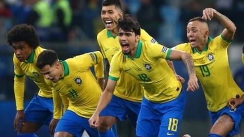 Brazil's players celebrate winning the penalty shootout