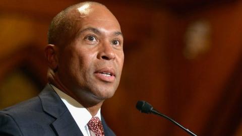 Deval Patrick stands at a podium