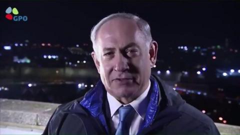 A picture of Israeli PM Benjamin Netanyahu standing outside in a coat