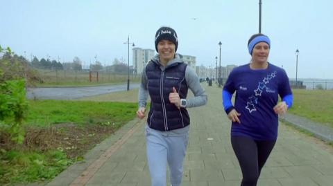 Two women running.