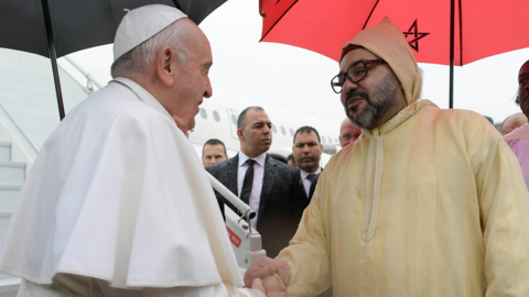 Pope Francis is greeted by Morocco's King Mohammed VI upon disembarking from his plane at Rabat-Sale International Airport