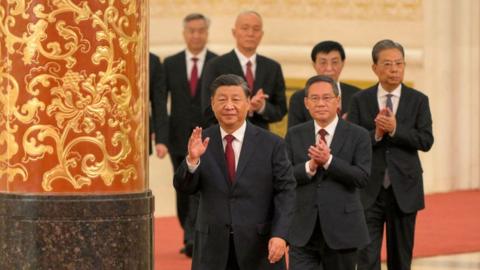 China's President Xi Jinping (front) walks with members of the Chinese Communist Party's new Politburo Standing Committee