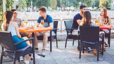 People sitting outside drinking