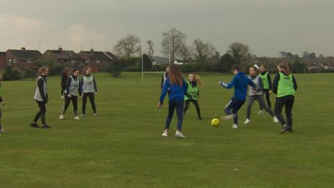 Northern Ireland football internationals Kirsty and Caitlin McGuinness returned to their old school St Genevieve's to help train potential stars of the future.