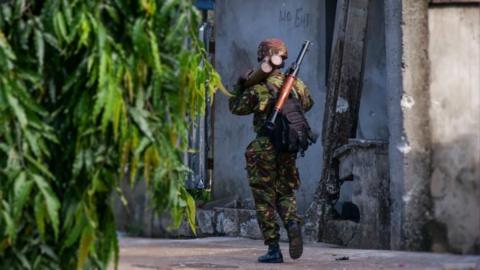 A soldier carries a rocket propelled grenade launcher in Freetown, Sierra Leone, 27 November 2023.