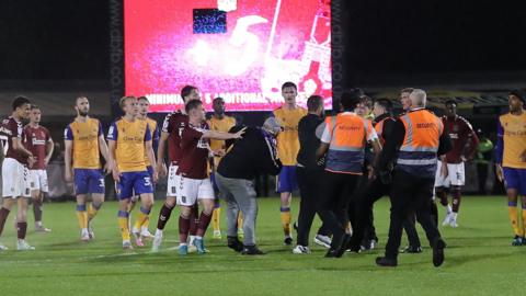 Pitch invasion at Sixfields