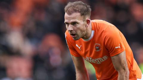 Jordan Rhodes looks dejected whilst playing for Blackpool