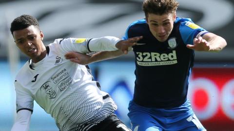 Swansea's Morgan Whittaker (L) challenges Ryan Ledson of Preston