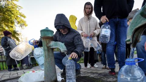 People take water from a water pump in Kyiv