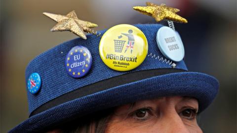 An anti-Brexit campaigner wearing a hat during a rally outside the Labour conference in Liverpool