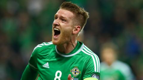 Steven Davis celebrates scoring against Greece