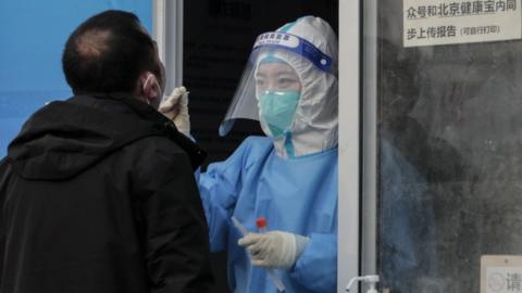 A man undergoes COVID-19 nucleic acid testing in Beijing, China