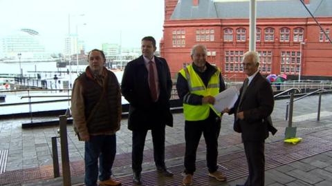 Stuart Davies handing the petition to David Rowlands AM