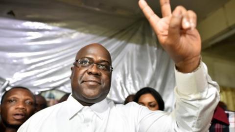 Felix Tshisekedi holds two fingers up in a victory sign