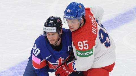 Great Britain and Czech Republic ice hockey players battle for the puck