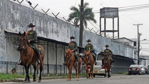 A handout photo made available by the Villavicencio Mayor's Office, shows a group of police officers patrolling the exterior of the Villavicencio Prison, in Villavicencio, Colombia, 21 March 2020