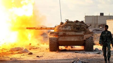 Tank fired as soldier walks ahead in Benghazi