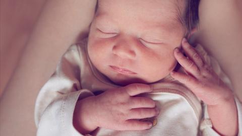 A newborn baby asleep