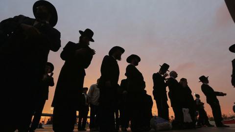 Orthodox Jews gather to celebrate the completion of study of the entire Talmud religious text in East Rutherford, New Jersey