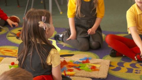 Schoolchildren sitting on a carpet