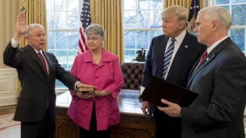 In this file photo taken on February 9, 2017 US President Donald Trump (2nd R) watches as Jeff Sessions (L), alongside his wife Mary (2nd L), is sworn in as Attorney General by US Vice President Mike Pence (R) in the Oval Office of the White House in Washington, DC