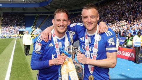 Marc Albrighton (left) and Jamie Vardy (right) pose with the Championship trophy