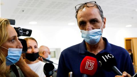 File photo showing Israeli media speaking to Shmulik Peleg outside a court in Tel Aviv, Israel (23 September 2021)