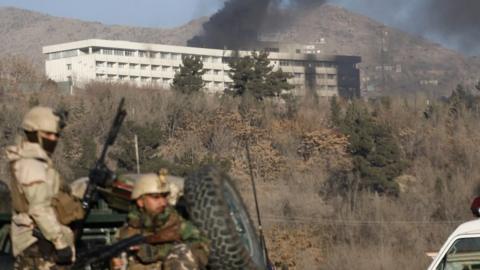 Afghan forces with hotel in background