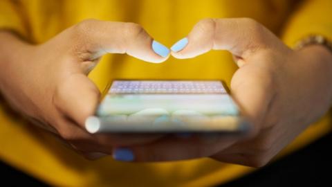 Woman sending text message