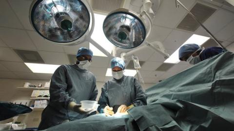 Surgeons working in an operating theatre