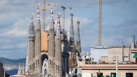 Barcelona's Sagrada Familia cathedral decorated with a Catalan banner for the national day of Catalonia