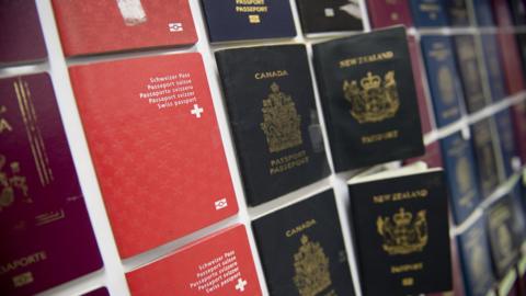 Fake passports displayed at immigration bureau in Bangkok on February 10, 2016