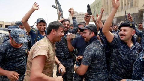 Iraqi Federal police celebrate in the Old City of Mosul, 8 July