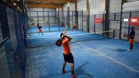 Four people playing padel