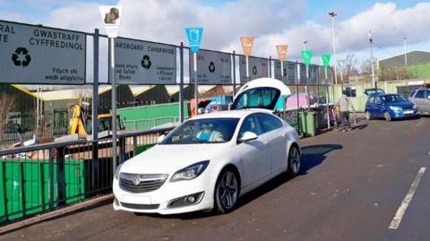 A recycling centre in Caerphilly, with cars queueing to deposit materials