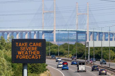 Heat warning matrix sign with the Severn Bridge in the background