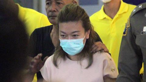 A handout photo made available by the Royal Thai Police shows police officers escort a suspect Thai Sararat Rangsiwuthaporn, who is accused of killing at least twelve victims with cyanide, to the criminal court in Bangkok, Thailand, 26 April 2023.