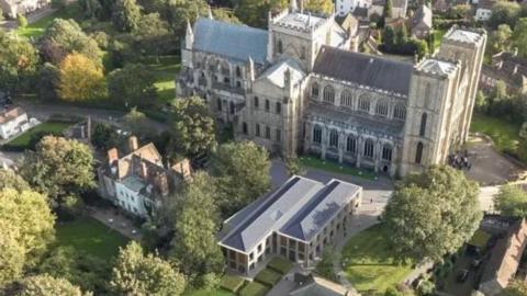 An aerial view of Ripon Cathedral with a CGI image in the foreground showing the proposed annex