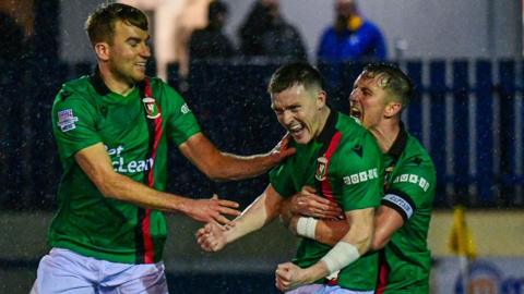 Daniel Larmour and Marcus Kane celebrating with James Singleton 