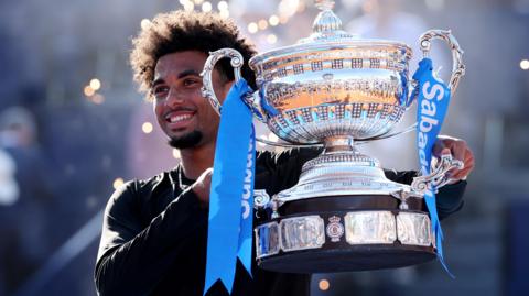 Arthur Fils holds the trophy after winning in Barcelona