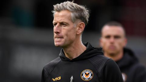 Newport County head coach Dave Hughes in a black hoodie