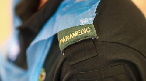 A close-up picture of a paramedic in a uniform.