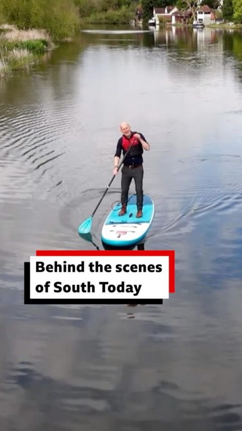A man paddleboarding down the River Thames
